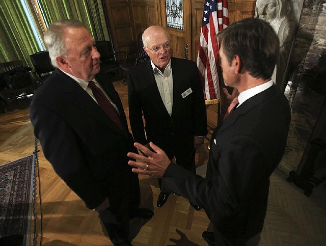 Mike Roach (center), president of Ben E. Keith Co., talks Tuesday with North Little Rock Mayor Joe Smith (left) and Matt Erskine with the federal Economic Development Administration. 