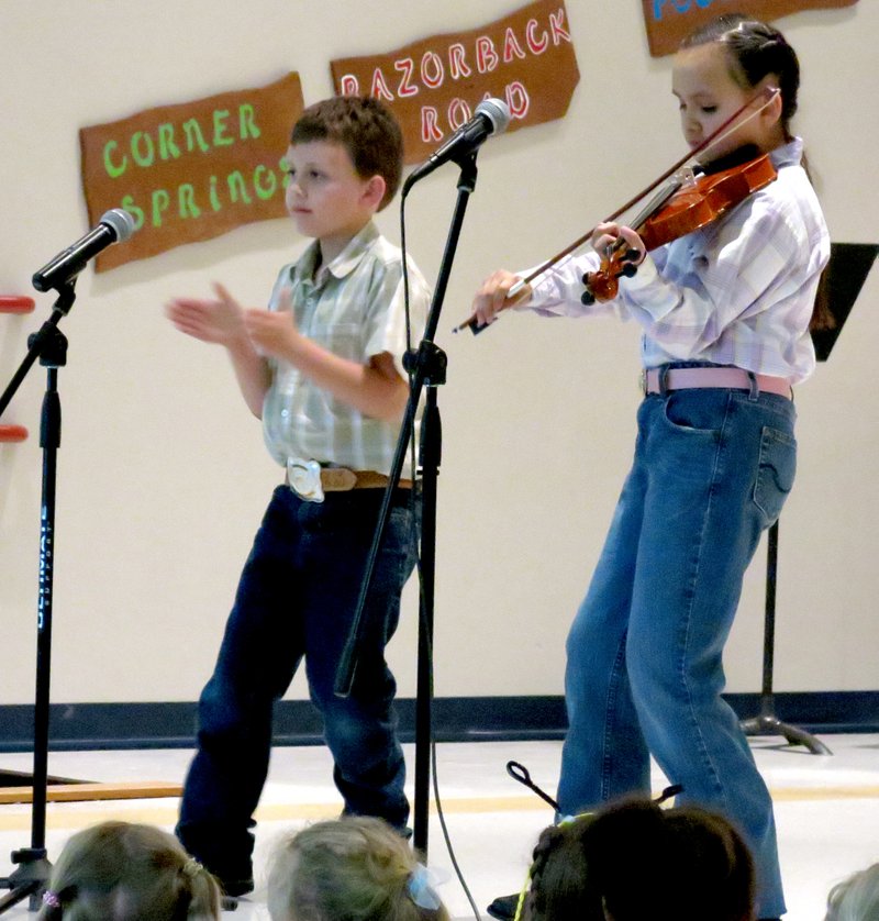 Photo by Mike Eckels Martha Smith Gomez and brother Emilio take center stage with a toe-tapping, hand-clapping, fiddle-playing rendition of &#8220;Shortnin&#8217; Bread.&#8221; Both Gomezes were part of the entertainment at Northside Elementary&#8217;s &#8220;Arkansas Night&#8221; on May 7.