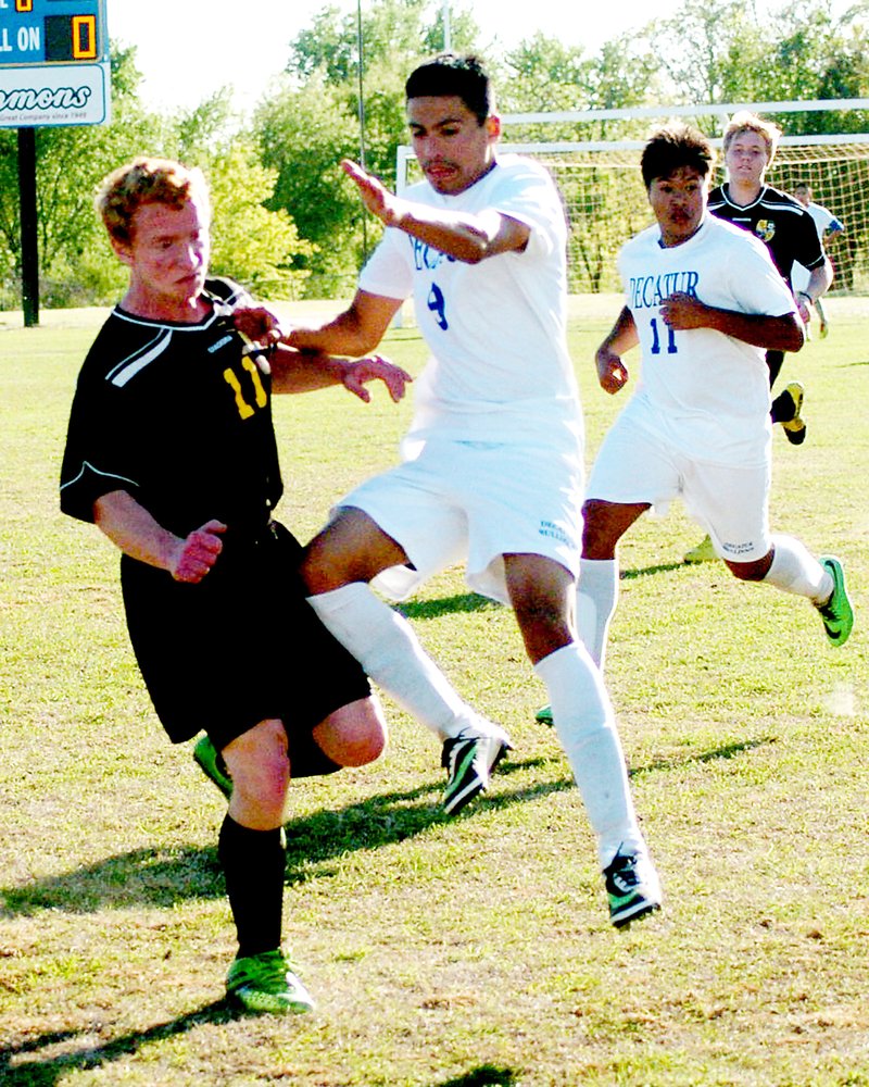 Photo by Mike Eckels Tony Mendoza moves the ball down field in an effort to score one more goal May 2 as he played his final game with Decatur in Bulldog Stadium. Mendoza was named to the 2014 All State soccer team April 28. He scored only one goal in this match with Prairie Grove and two against Rogers Heritage May 1.