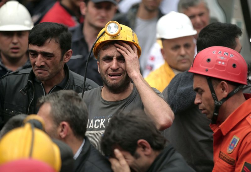 A miner cries as rescue workers carry the dead body of a miner from the mine in Soma, western Turkey, on Wednesday, May 14, 2014. An explosion and fire at the coal mine killed at least 232 workers, authorities said, in one of the worst mining disasters in Turkish history. Turkey's Energy Minister Taner Yildiz said 787 people were inside the coal mine at the time of the accident.