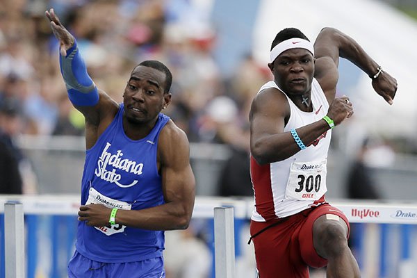 Indiana State's Greggmar Swift, left, collides with Arkansas' Omar McCleod at the finish line of the university men's 110-meter hurdles during the Drake Relays athletics meet, Saturday, April 26, 2014, in Des Moines, Iowa. Swift finished in second place and McLeod third. (AP Photo/Charlie Neibergall)