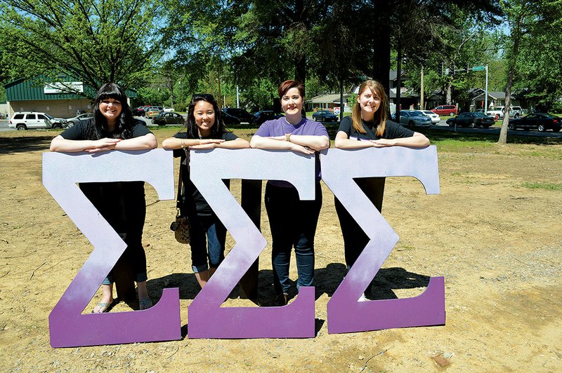 Members and an alumna of Sigma Sigma Sigma sorority at the University of Central Arkansas in Conway stand with their Greek letters on the site where their chapter house will be built as part of the Greek Village. From left are Hannah McCallister of Benton, a sophomore; Jordyn Kaga of Maui, Hawaii, a junior; Kimberly Irizarry of Little Rock, an alumna; and Nicole Turney of Greenbrier, a sophomore.