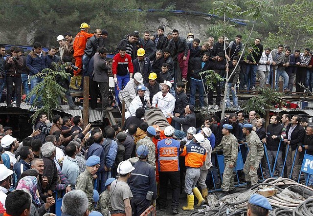Rescuers carry an injured miner out of a coal mine Wednesday in Soma in western Turkey as hundreds of relatives and miners wait for news of those still inside. 