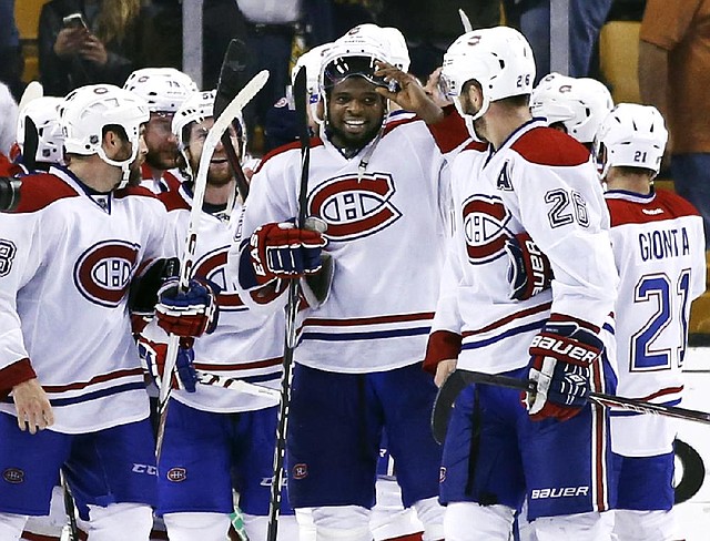 Defenseman P.K. Subban (center) celebrates with teammates after the Montreal Canadiens defeated the Boston Bruins on Wednesday night in Game 7 of their NHL playoff series. 