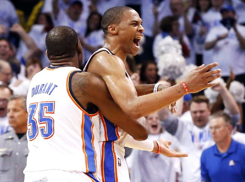 Russell Westbrook (right) and Kevin Durant celebrate the Oklahoma City Thunder’s comeback victory over the Los Angeles Clippers on Tuesday night in the NBA Western Conference semifinals. 