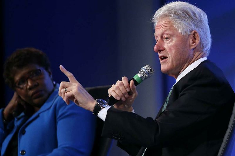 Former President Bill Clinton answers questions Wednesday at the 2014 Fiscal Summit in Washington, saying he was dumbfounded by Karl Rove’s suggestions that Hillary Rodham Clinton had been weakened by her 2012 concussion. 