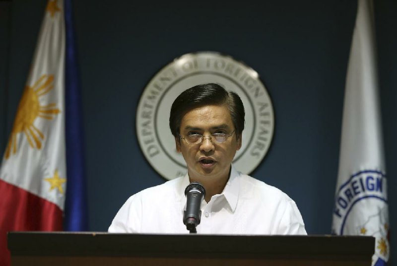 Philippine Foreign Affairs spokesman Charles Jose delivers a statement Wednesday concerning the Philippines’ protest over China’s reclamation of a disputed reef in the South China Sea. 