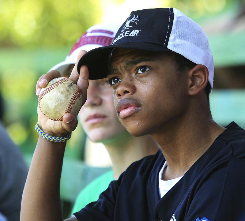 Benjamin Osler, 14, listens to instruction from coach Wayne Gray. “We maybe are not always the greatest coaches in the world, as far as the rules, the skills, all that stuff, but you know, that’s not all the important stuff. But we’re pretty good,” Gray says. 