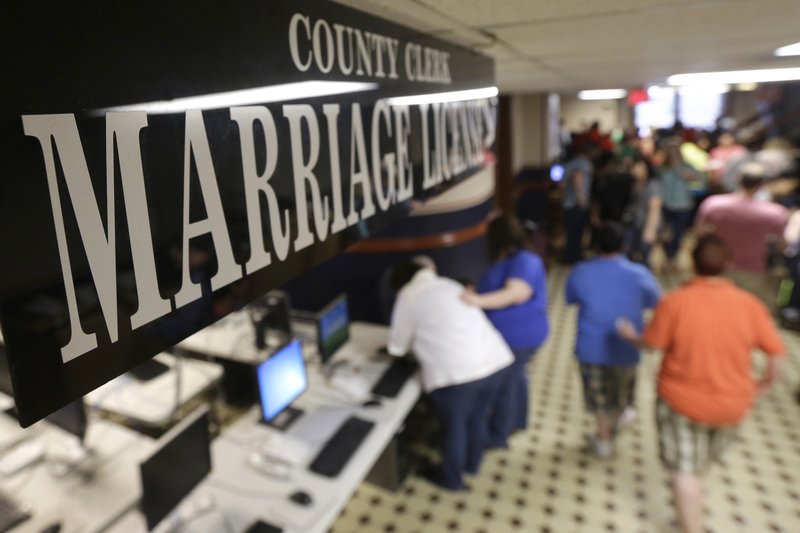 Couples line up at the County Clerk's window for marriage licenses at the Pulaski County Courthouse in Little Rock on Monday, May 12, 2014.