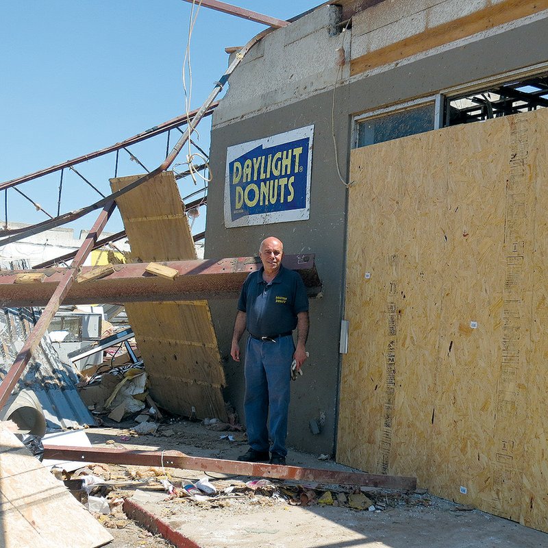Fred Muawad, the owner of Daylight Donuts in Vilonia, stands by the remains of his 11-year-old business that was destroyed by the April 27 tornado.