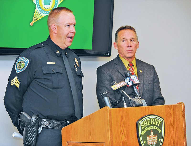 STAFF PHOTO ANDY SHUPE Sgt. Craig Stout, left, of the Fayetteville Police Department, speaks Thursday alongside Washington County Sheriff Tim Helder during a news conference to announce the firing of deputy Hayden Miller at the Sheriff&#8217;s Office in Fayetteville.