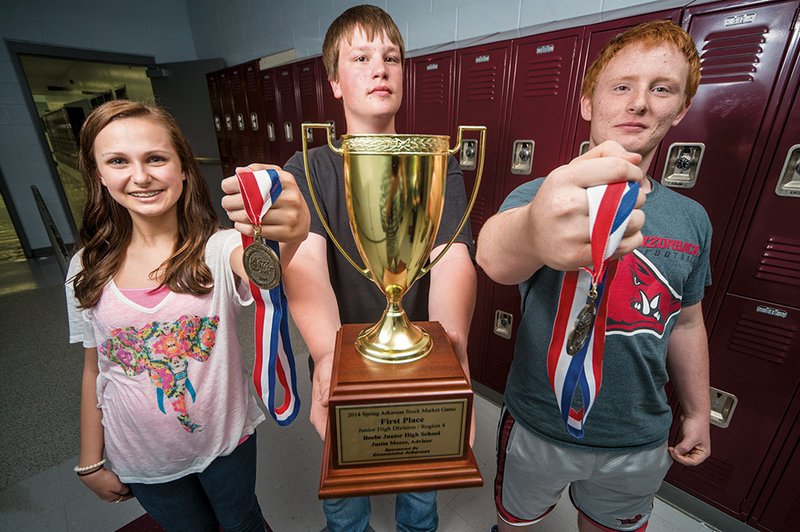 Ashley Courson, from left, Derrek Newell and Shannon Anderson were part of the Beebe High School teams that received cash awards and trophies for winning first and second place during the spring 2014 session of the Stock Market Game, a project-based investment simulation that teaches the importance of saving and investing for the future.

