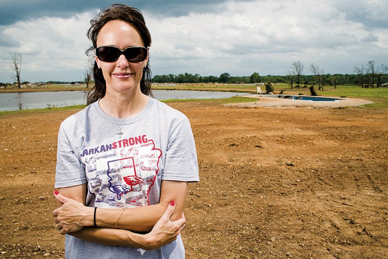 Lori Patterson stands on the lot in Vilonia where her home was before it was hit by the April 27 tornado. The debris has been cleared — the only thing left is a storm shelter and a damaged inground pool. Patterson’s husband, Teddy, died five years ago this month, and a photo of him was found in a yard in Batesville after the storm tore through Faulkner County.