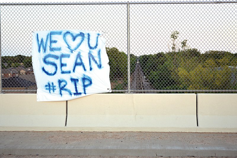 This banner was hung on the Salem Road overpass in Conway above the railroad tracks where Sean Studler, 17, was killed as he walked west from his neighborhood, which can be seen at left in the photo. Members of his family said they don’t know who put up the banner, which has since been destroyed by rain.