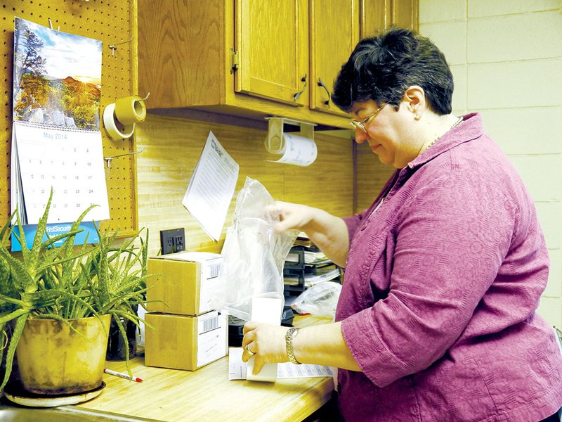 Cherie Bradley prepares soil samples to be sent to the agricultural testing lab in Marianna. The White County Cooperative Extension Service provides free soil testing for residents in preparation for their gardening projects.