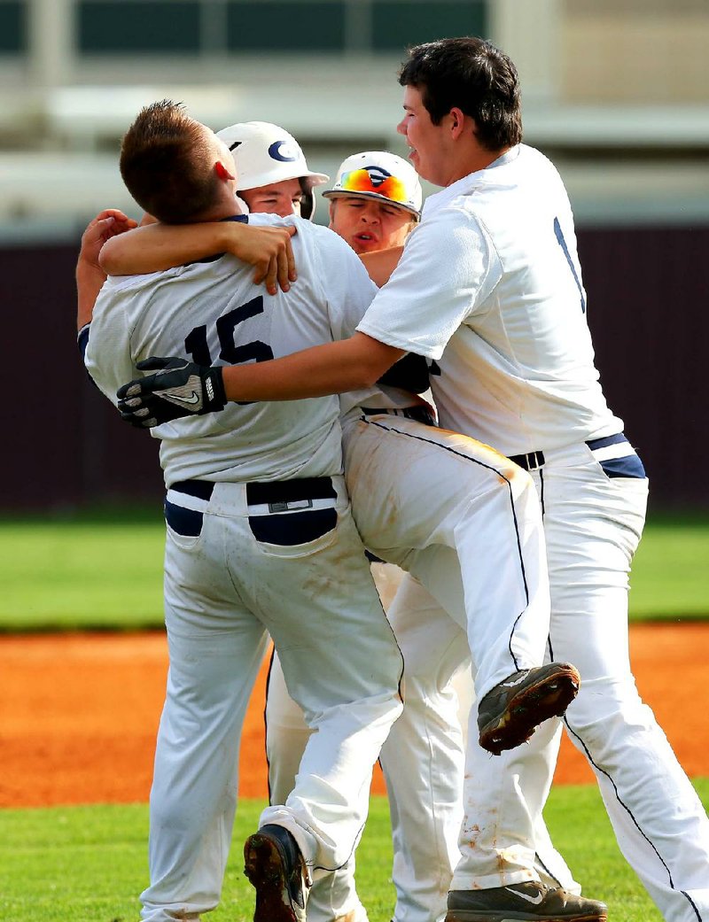 5/15/14
Arkansas Democrat-Gazette/STEPHEN B. THORNTON
Greenwood teammebers swarm  Tanner Cooper, second from left, after his hit drove in the winning run in extra innings to defeat Texarkana in their 6A state baseball tournament Thursday in Benton. 
