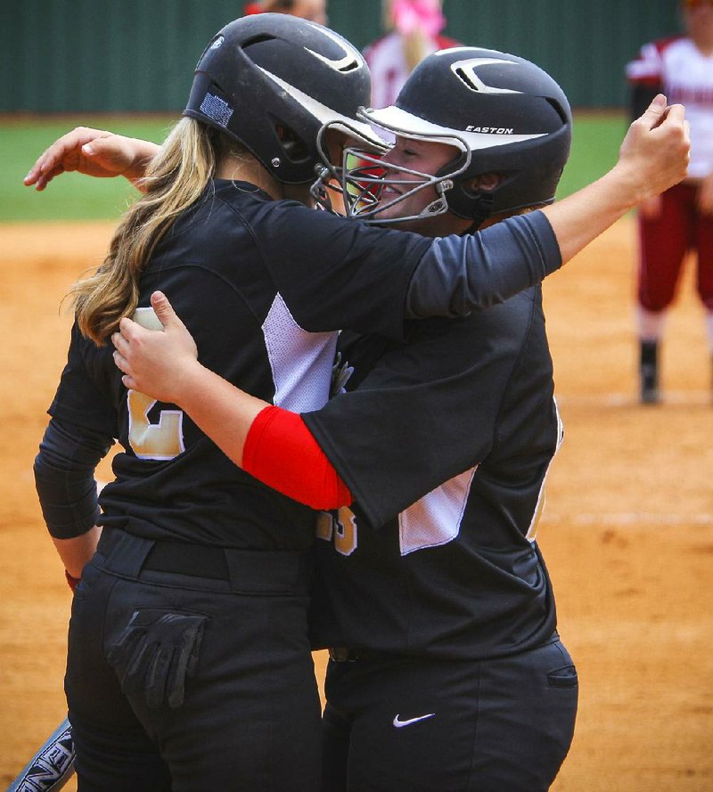 5/15/14
Arkansas Democrat-Gazette/STEPHEN B. THORNTON
Jonesboro's Susannah Kelley, left, congratulates Madi Bishop, right, after Bishop hit a three run home run  in the third inning  of their 6A state softball tournament Thursday in Benton.