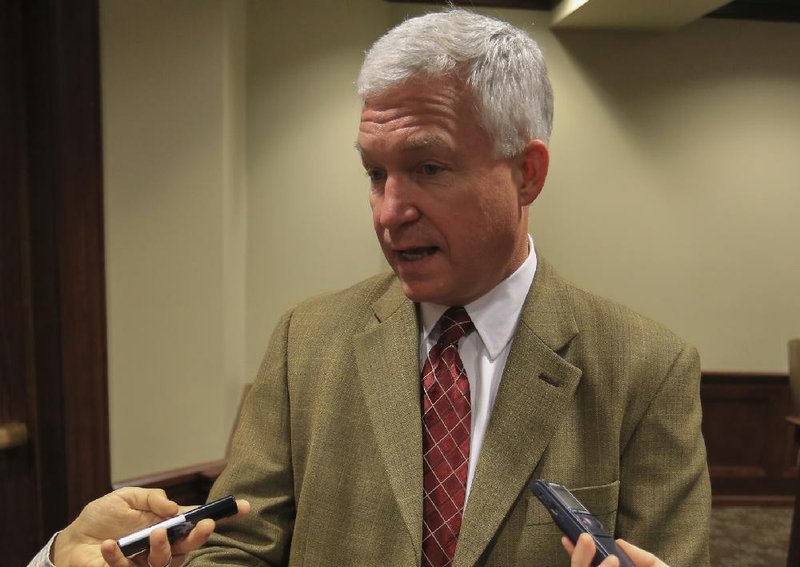 Arkansas Surgeon General Joe Thompson answers questions Thursday after a legislative meeting on the private option. 