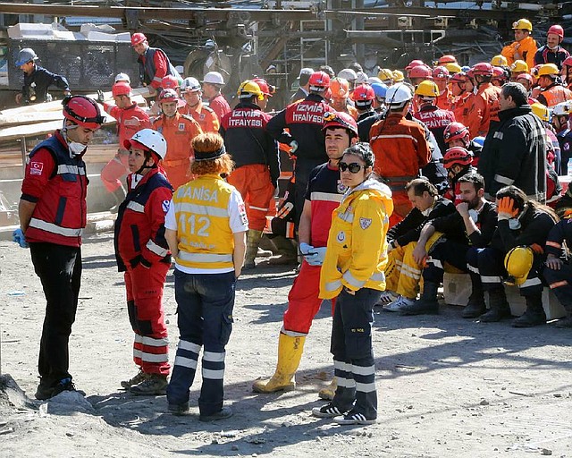 Rescue workers and medics wait outside the coal mine in Soma, Turkey, Thursday, May 15, 2014. An explosion and fire at a coal mine in Soma, some 250 kilometers (155 miles) south of Istanbul, killed hundreds of workers, authorities said, in one of the worst mining disasters in Turkish history.(AP Photo/Berza Simsek)