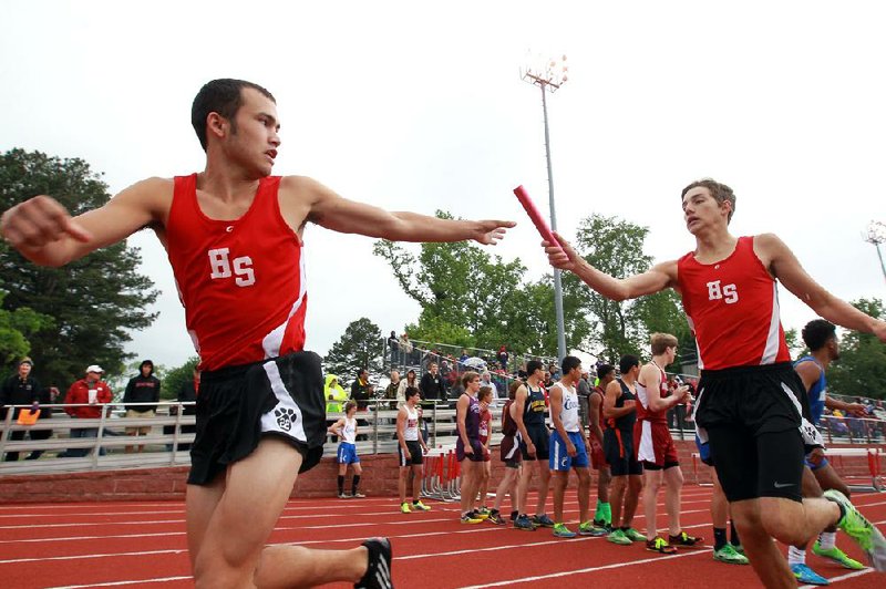 Arkansas Democrat-Gazette/BENJAMIN KRAIN --05/17/14--
Heber Springs Malachi Cannon, left, takes a handoff from Patrick Hill in the 4x800 meter relay while setting a school record and winning the event with a time of 8 minutes 5.6 seconds during the Meet of Champs held Saturday.