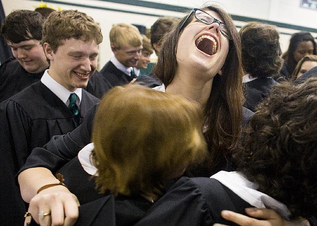 Arkansas Democrat-Gazette/MELISSA SUE GERRITS - 05/17/2014 -  Claire Jeter cheers while hugging friends after graduating from Episcopal Collegiate School May 17, 2014. Jeter plans to attend Roger Williams University. 