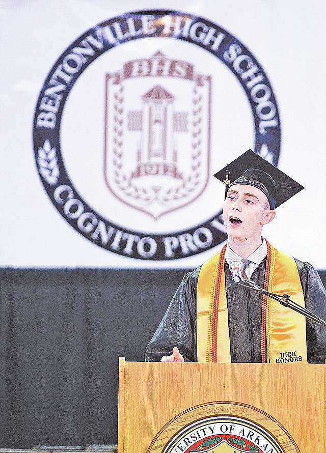 STAFF PHOTO SAMANTHA BAKER &#8226; @NWASamantha Dylan Deluca gives the student address to Bentonville High School graduates Saturday at Bud Walton Arena in Fayetteville. Bentonville High School had more than 870 students complete graduation requirements in order to get their diploma.