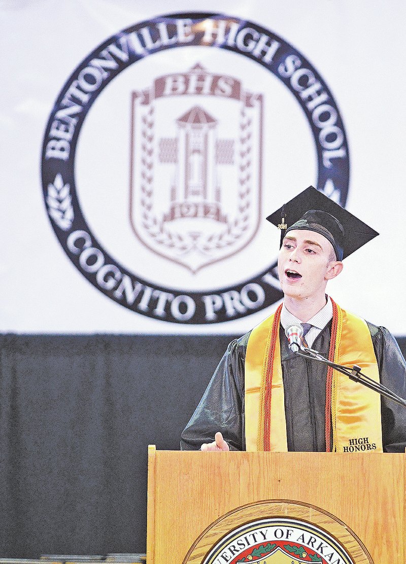 STAFF PHOTO SAMANTHA BAKER &#8226; @NWASamantha Dylan Deluca gives the student address to Bentonville High School graduates Saturday at Bud Walton Arena in Fayetteville. Bentonville High School had more than 870 students complete graduation requirements in order to get their diploma.