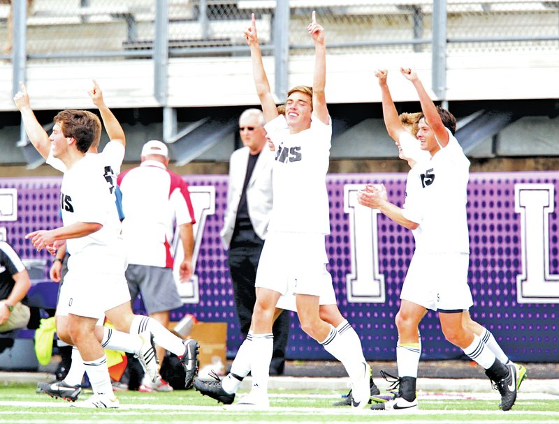  STAFF PHOTO JASON IVESTER Bentonville players celebrate following the goal by junior Spencer McMillon, center, during the second half on Saturday during their Class 7A semifinal match against Springdale at Harmon Field in Fayetteville.