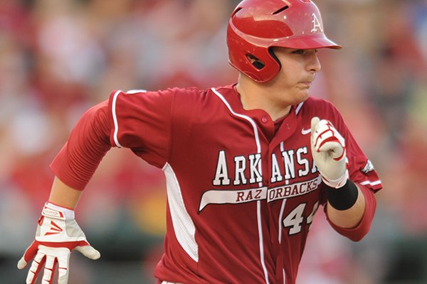 Arkansas catcher Alex Gosser heads to first after hitting the ball against Texas A&M during the fourth inning Friday, May 9, 2014, at Baum Stadium in Fayetteville.