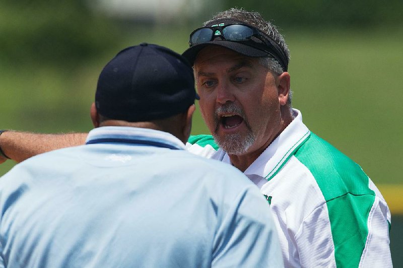 Special to the Arkansas Democrat-Gazette/CHRIS BRASHERS - 05/19/2014 - Van Buren Coach (unknown) disputes a call during action at the Arkansas 7A Softball Championships in Conway, May 19, 2014