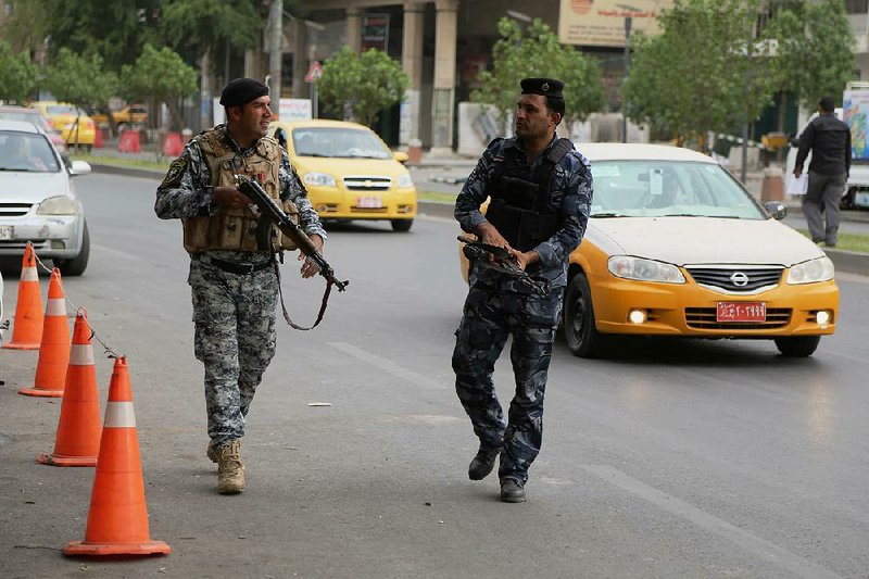 Iraqi policemen go on a foot patrol in central Baghdad, Iraq, Monday, May 19, 2014. The Iraqi government has tightened its security measures after releasing the results of the country’s parliamentary elections. A coalition led by Iraq’s Shiite Prime Minister Nouri al-Maliki emerged Monday as the biggest winner in the country’s first parliamentary elections since the U.S. military withdrawal in 2011, electoral officials said, as the embattled premier is seeking a third term in office despite political turmoil and rising violence. (AP Photo/Karim Kadim)