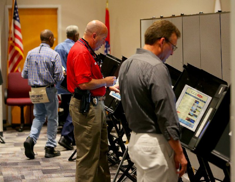 5/19/14
Arkansas Democrat-Gazette/STEPHEN B. THORNTON
Pulaski County voters line electronic machines as they early vote in the primary election Tuesday at the Pulaski County Regional Building at 501 W. Markham in Little Rock. 