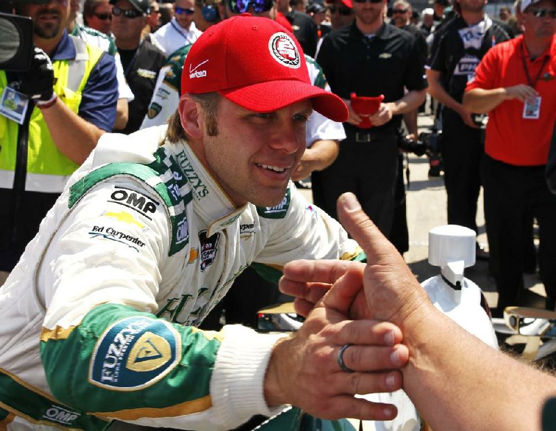 Ed Carpenter is congratulated by a crew member after wining the pole during qualifications for the Indianapolis 500 IndyCar auto race at the Indianapolis Motor Speedway in Indianapolis, Sunday, May 18, 2014. (AP Photo/Tom Strattman)