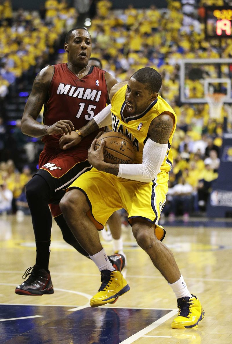 Indiana Pacers' C.J. Watson (32) is fouled by Miami Heat's Mario Chalmers as he goes to the basket during the second half of Game 1 of the Eastern Conference finals NBA basketball playoff series Sunday, May 18, 2014, in Indianapolis. Indiana defeated Miami 107-96. (AP Photo/Darron Cummings)