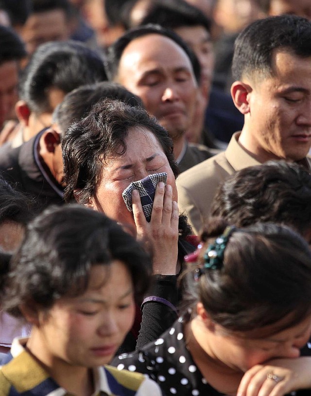 In this Saturday, May 17, 2014 photo, families of victims of an accident at an apartment construction site in Pyongyang, North Korea, grieve during a gathering in the capital where senior officials apologized and took responsibility. The word of the collapse in the secretive nation's capital was reported Sunday morning, May 18 by the North's official Korean Central News Agency, which gave no death toll but said that the accident was "serious" and upset North Korea's leader, Kim Jong Un. (AP Photo/Jon Chol Jin)