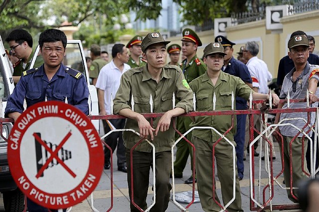 Vietnamese security officers set up a fence outside an area of the Chinese Embassy in Hanoi, Vietnam on Sunday, May 18, 2014.  Vietnamese authorities forcibly broke up small protests against China in two cities on Sunday, after deadly anti-China rampages over a simmering territorial dispute risked damaging the economy and spooked a state used to keeping a tight grip on its people. In southern Ho Chi Minh City, police dragged away several demonstrators from a park in the city center. In Hanoi, authorities closed off streets and a park close to the Chinese Embassy and pushed journalists and protesters away. (AP Photo/Na Son Nguyen)