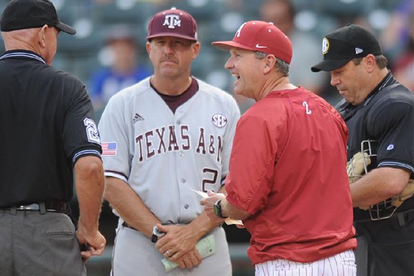 Texas A&M coach Rob Childress, left, and Arkansas coach Dave Van Horn meet with umpires prior to a game Friday, May 9, 2014 at Baum Stadium in Fayetteville. Childress was an assistant coach to Van Horn for 10 seasons. 