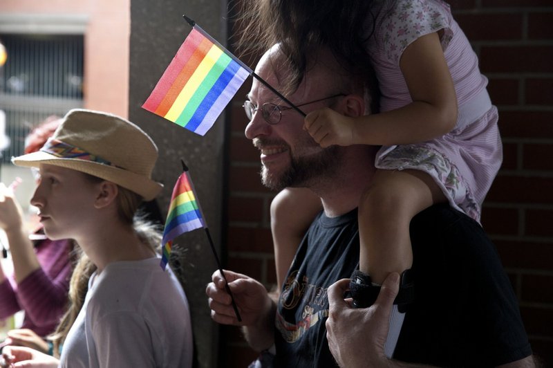 Supporters of same-sex marriage wait at the Multnomah Building in Portland, Ore., for a federal judge's ruling on whether to overturn Oregon's ban on gay marriage Monday, May 19, 2014. Celebration and the issuing of marriage licenses followed the decision to overturn. 