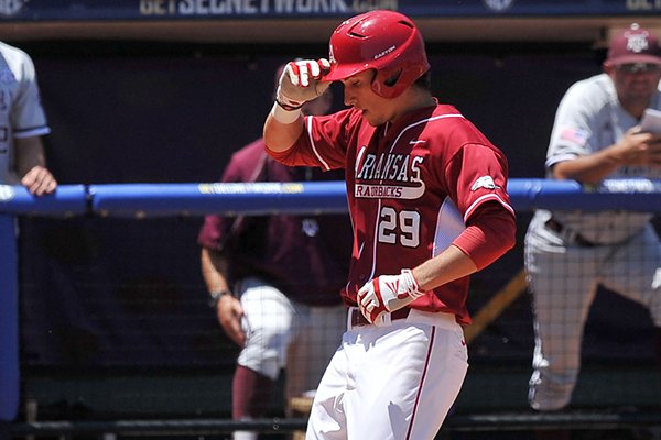 Arkansas' Eric Fisher crosses home plate after hitting a solo home run in the second inning of the Razorbacks' game against Texas A&M on Tuesday at the SEC Tournament in Hoover, Ala. 