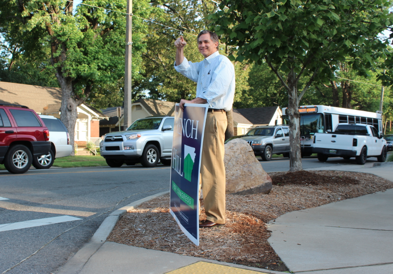 French Hill points at a supporter Tuesday morning at Cantrell Road and Kavanaugh Boulevard.