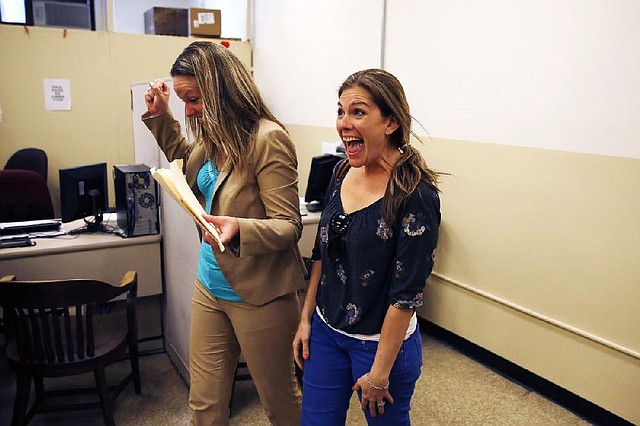 Ashley Wilson (left) and Lindsay Vandermay, both 29, react after getting their marriage license at the Philadelphia Marriage Bureau in City Hall on Tuesday in Philadelphia. Pennsylvania’s ban on gay marriage was overturned by a federal judge Tuesday. 