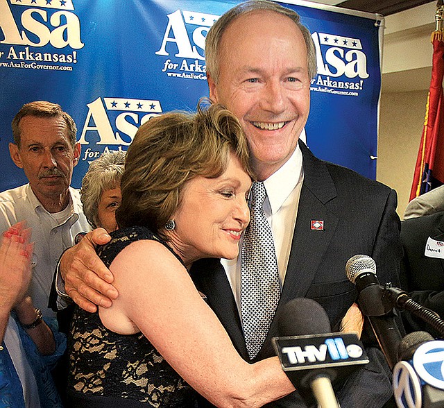 Asa Hutchinson celebrates with his wife, Susan, after addressing supporters Tuesday night at an election-watch party in Little Rock. 