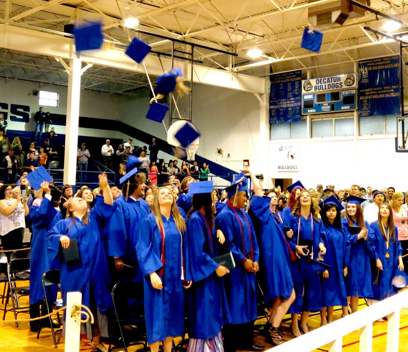 Photo by Mike Eckels Mortarboards fly as the Class of 2014 celebrate their graduation from Decatur High School May 17.
