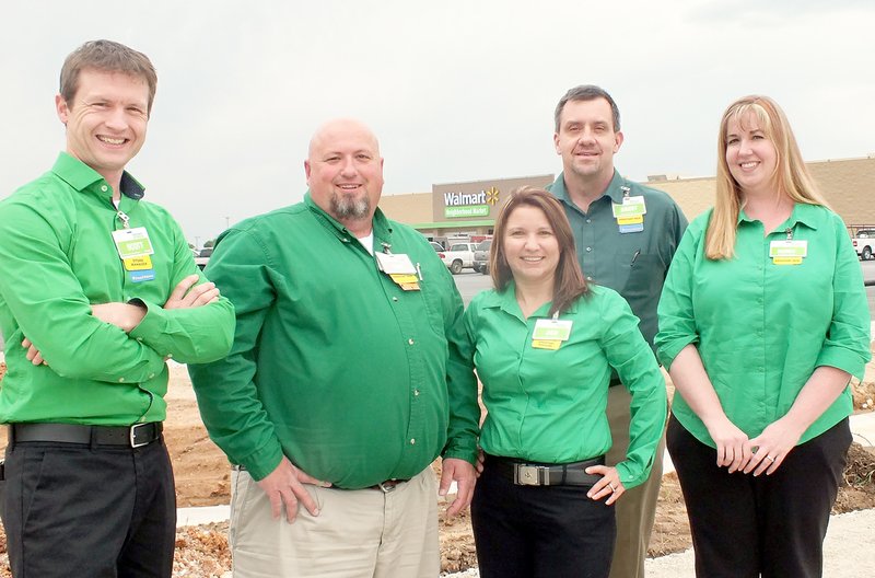 TIMES photograph by Annette Beard Scott McMillan, manager of the Neighborhood Market in Pea Ridge, and assistant managers Tony Bauhaus, Jennifer Cole, Brent Taylor and Audra Miller eagerly await the July 16 grand opening of the new store.