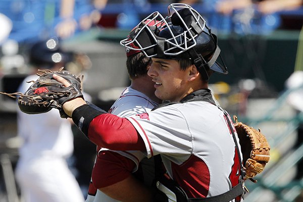 Arkansas' Alex Gosser, right, celebrates with Jacob Stone after Arkansas defeated Mississippi 2-1 at the Southeastern Conference NCAA college baseball tournament Wednesday, May 21, 2014, in Hoover, Ala. (AP Photo/Butch Dill)