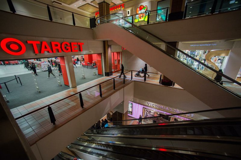 Shoppers ride escalators near a Target Corp. store at the Atlantic Terminal Mall in the Brooklyn borough of New York in March. Target said Wednesday it earned $418 million, or 66 cents per share, in the first quarter.