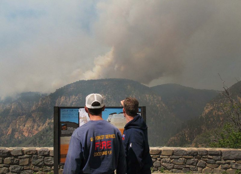 Coconino National Forest Battalion Chief Preston Mercer (left) and fire information officer Bill Morse survey a fire Wednesday in Oak Creek Canyon, Ariz., as crews face off with a raging blaze. 