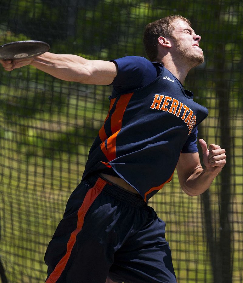 Rogers Heritage senior Daniel Spickes (left) vaulted to the top of the Arkansas high school track and field scene Thursday by winning the 51st annual high school decathlon at Panther Stadium in Cabot. Spickes, the runner-up last year, went into Thursday in second place behind Springdale Har-Ber’s Sain-Thomas Mathew but cleared 14 feet, 5 ½ inches in the pole vault to surpass Mathew on the final day of competition. Spickes finished with 6,488 points.