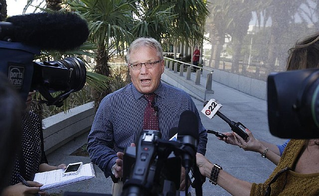 Cpl. Anthony Bertagna, Public Information Officer for the Santa Ana Police Department describes how a missing girl was located after 10 years during a media briefing outside the police station, Wednesday, May 21, 2014 in Santa Ana, Calif. (AP Photo/Chris Carlson)