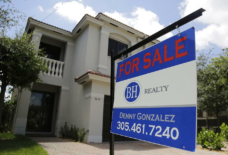 This Monday, May 19, 2014 photo shows a duplex home for sale in the Coconut Grove neighborhood in Miami. The National Association of Realtors reports on existing-home sales in April on Thursday, May 22, 2014. (AP Photo/Lynne Sladky)
